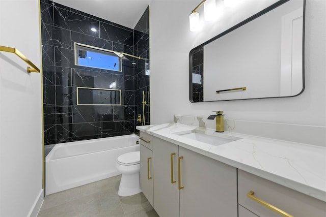 full bathroom featuring tiled shower / bath, tile patterned floors, toilet, and vanity