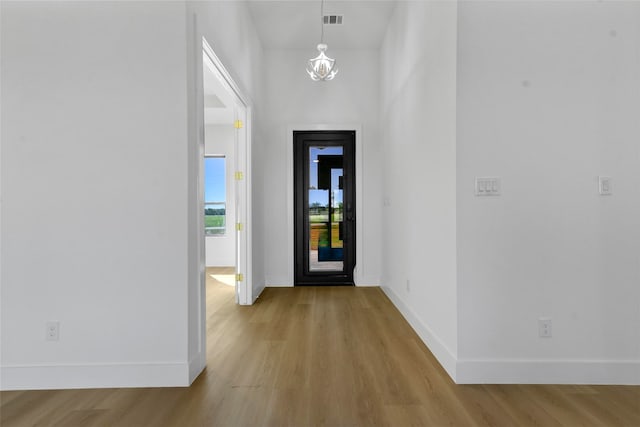 entrance foyer featuring light hardwood / wood-style flooring and an inviting chandelier