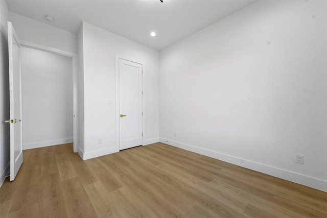 unfurnished bedroom with a closet and light wood-type flooring