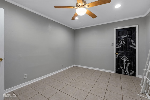 tiled empty room with ceiling fan and crown molding