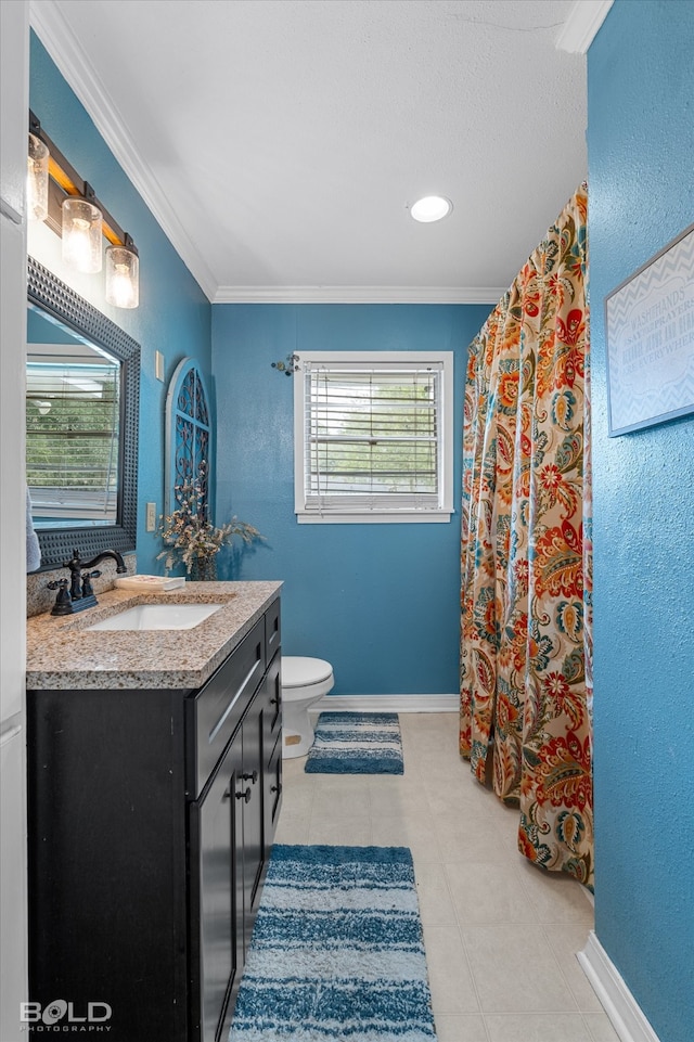 bathroom with tile patterned flooring, vanity, toilet, and crown molding