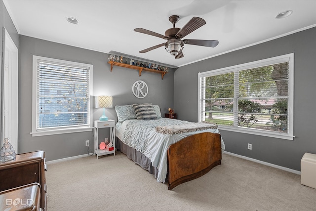 carpeted bedroom featuring multiple windows, crown molding, and ceiling fan