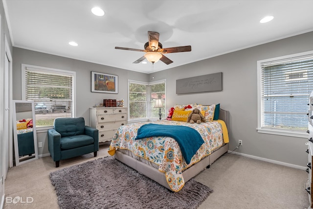 carpeted bedroom featuring multiple windows and ceiling fan