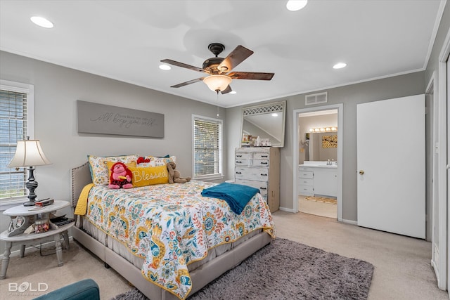 carpeted bedroom with connected bathroom, ceiling fan, crown molding, and sink