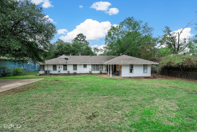 single story home featuring central air condition unit and a front lawn