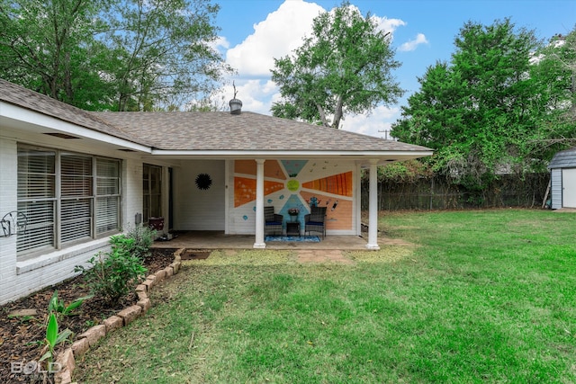 view of yard featuring ceiling fan, a patio, and a storage shed