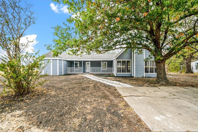 single story home featuring covered porch