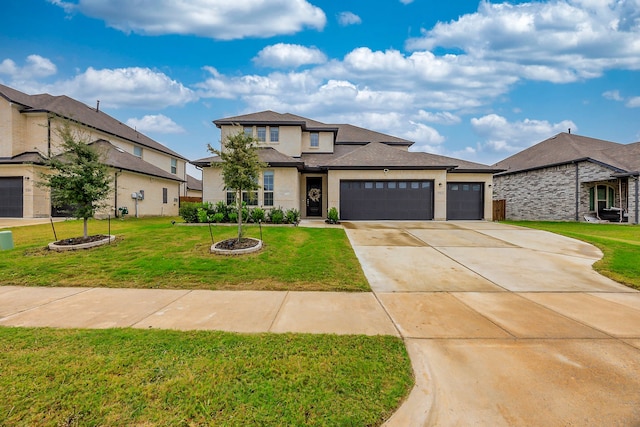 view of front of home with a front yard and a garage