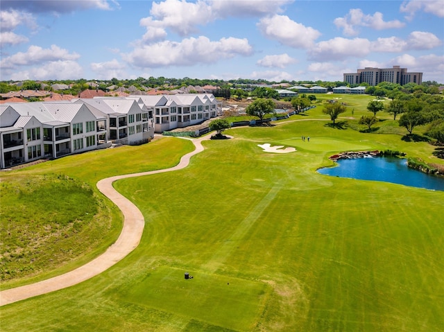 birds eye view of property with a water view and golf course view