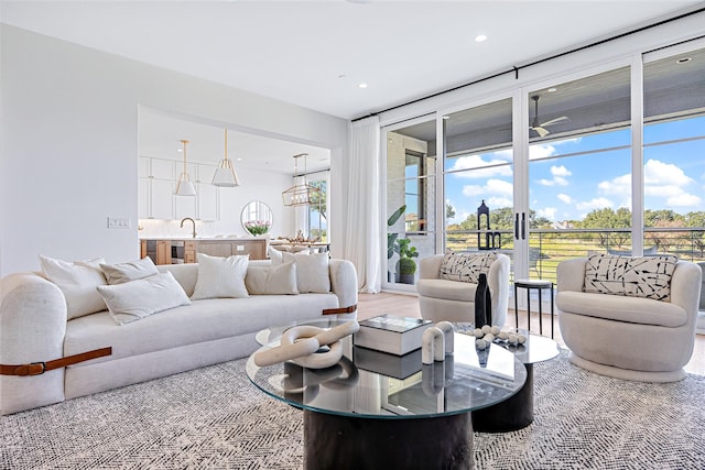 living room with expansive windows, wood finished floors, and recessed lighting