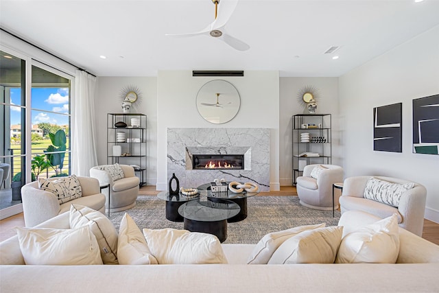 living area with a fireplace, wood finished floors, visible vents, and recessed lighting