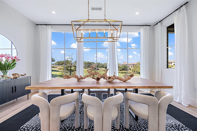 dining area with visible vents, a chandelier, wood finished floors, and recessed lighting