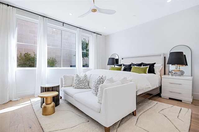 bedroom featuring light wood finished floors, ceiling fan, and recessed lighting