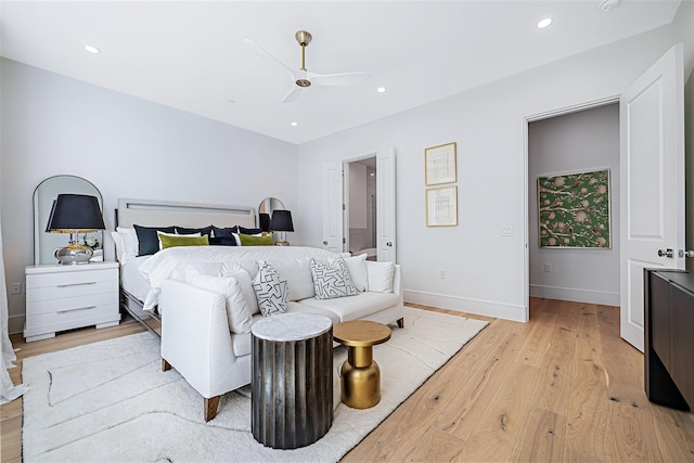 bedroom featuring light wood finished floors, recessed lighting, and baseboards