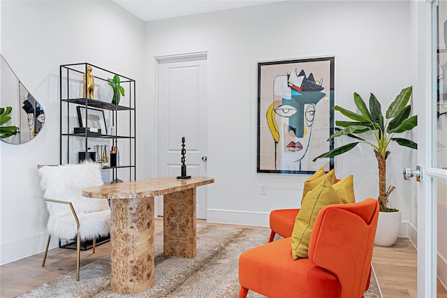 living area featuring baseboards and wood finished floors