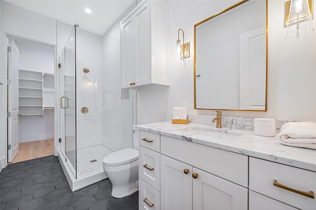 full bath featuring toilet, recessed lighting, vanity, a shower stall, and tile patterned floors