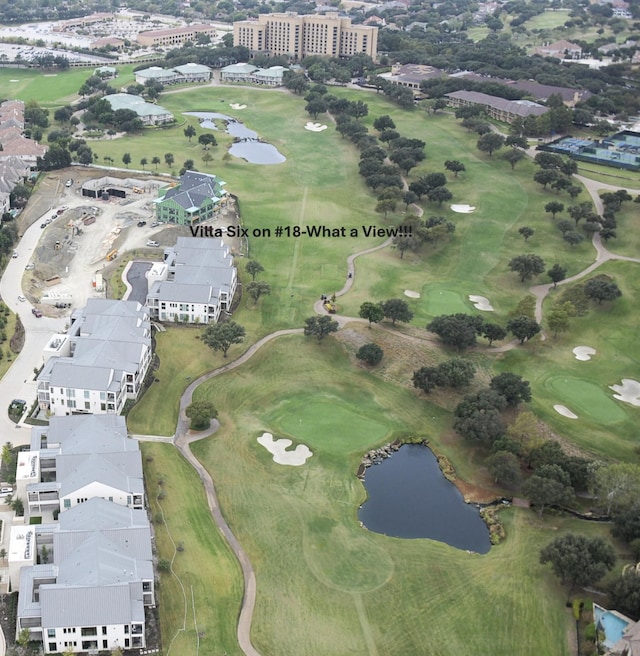 aerial view with a water view and golf course view