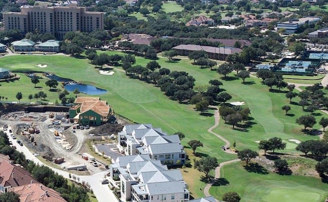 drone / aerial view featuring view of golf course and a water view