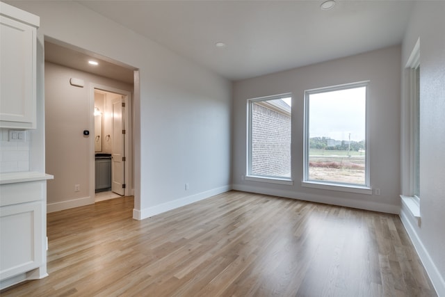 spare room with light hardwood / wood-style floors