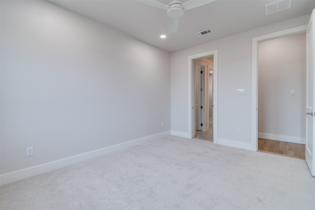 unfurnished bedroom with ceiling fan and light carpet