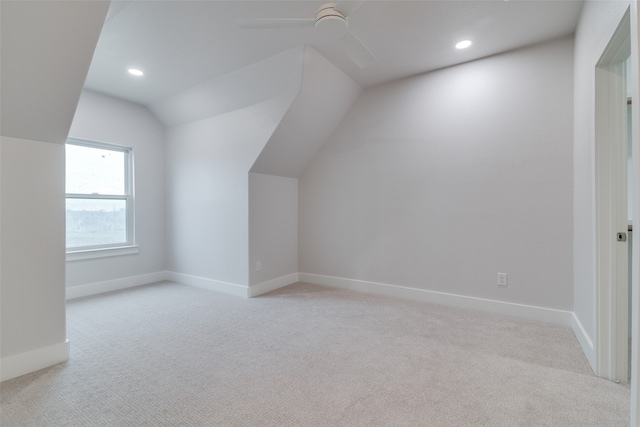 bonus room with light colored carpet, vaulted ceiling, and ceiling fan