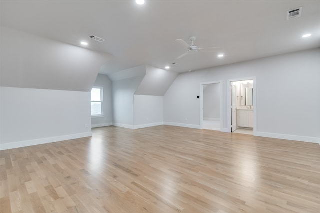 bonus room featuring ceiling fan, light hardwood / wood-style flooring, and vaulted ceiling