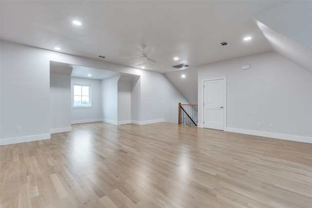 interior space with ceiling fan, lofted ceiling, and light wood-type flooring