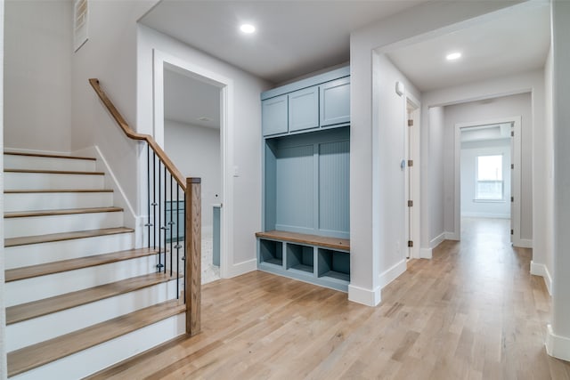 mudroom with light hardwood / wood-style floors