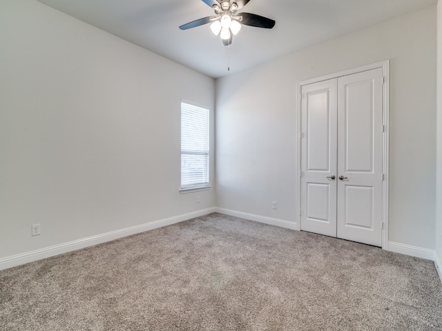 unfurnished bedroom with a closet, light carpet, and ceiling fan