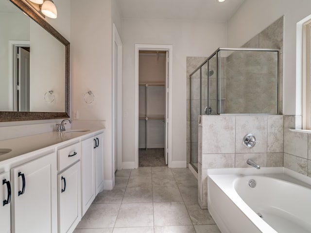 bathroom with vanity, tile patterned flooring, and shower with separate bathtub