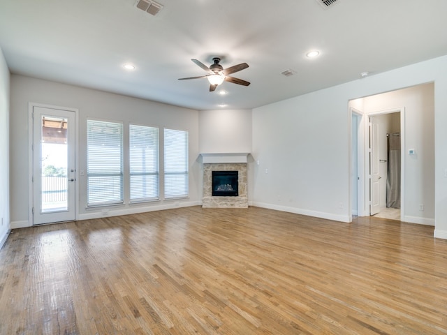 unfurnished living room with ceiling fan and light hardwood / wood-style flooring