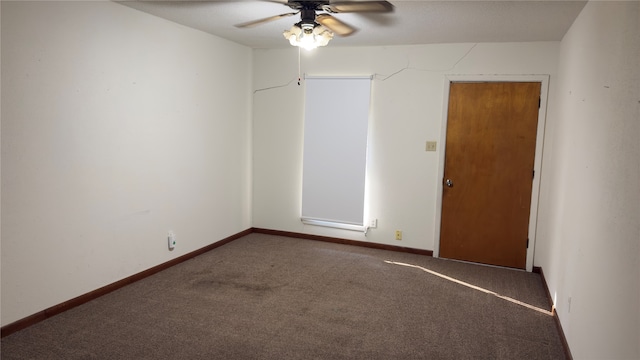 unfurnished room with ceiling fan and carpet