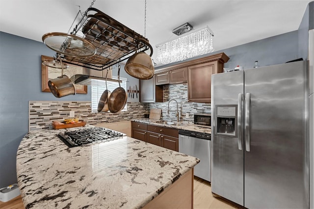 1246 Woodburn Trl, Dallas, TX 75241 - kitchen featuring stainless steel appliances, a sink, tasteful backsplash, and light stone counters
