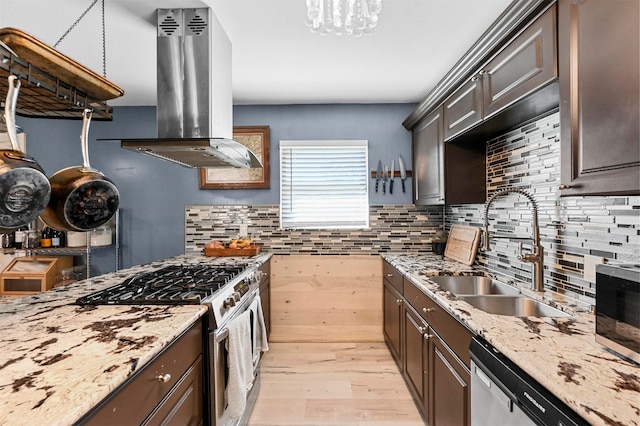 1246 Woodburn Trl, Dallas, TX 75241 - kitchen featuring island range hood, stainless steel appliances, a sink, light wood-style floors, and dark brown cabinets
