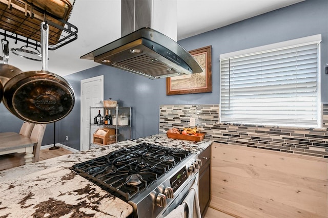 1246 Woodburn Trl, Dallas, TX 75241 - kitchen with island range hood, gas stove, and tasteful backsplash