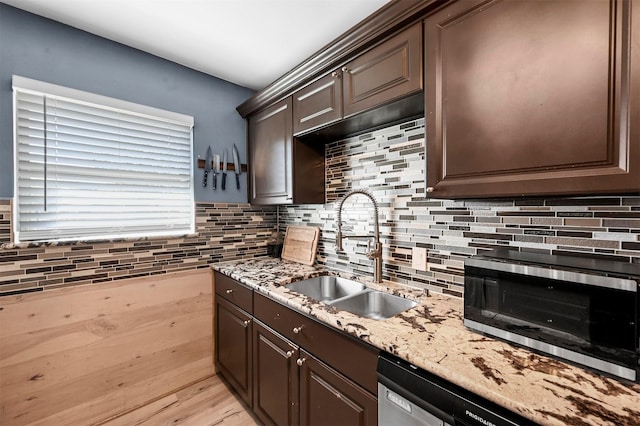 1246 Woodburn Trl, Dallas, TX 75241 - kitchen with a sink, dark brown cabinets, decorative backsplash, appliances with stainless steel finishes, and light stone counters