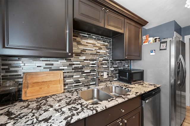 1246 Woodburn Trl, Dallas, TX 75241 - kitchen with black microwave, stainless steel dishwasher, a sink, tasteful backsplash, and dark brown cabinetry