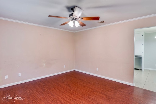 unfurnished room with light hardwood / wood-style floors, ceiling fan, and crown molding