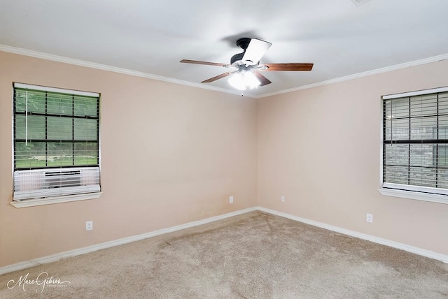 unfurnished room with light colored carpet, ceiling fan, and crown molding