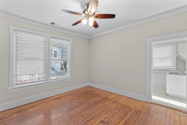 unfurnished room with hardwood / wood-style flooring, ceiling fan, and crown molding