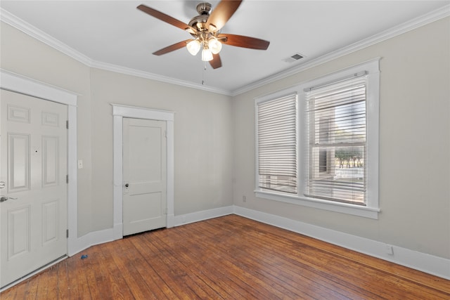 unfurnished room with hardwood / wood-style floors, ceiling fan, and crown molding