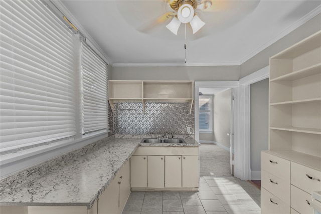 kitchen featuring ornamental molding, sink, light stone counters, and ceiling fan