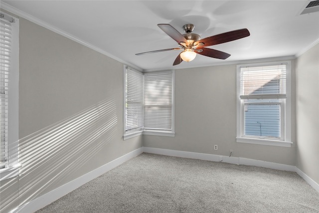 carpeted spare room featuring ceiling fan and crown molding