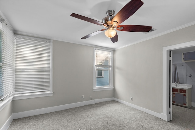 carpeted spare room featuring ceiling fan and ornamental molding