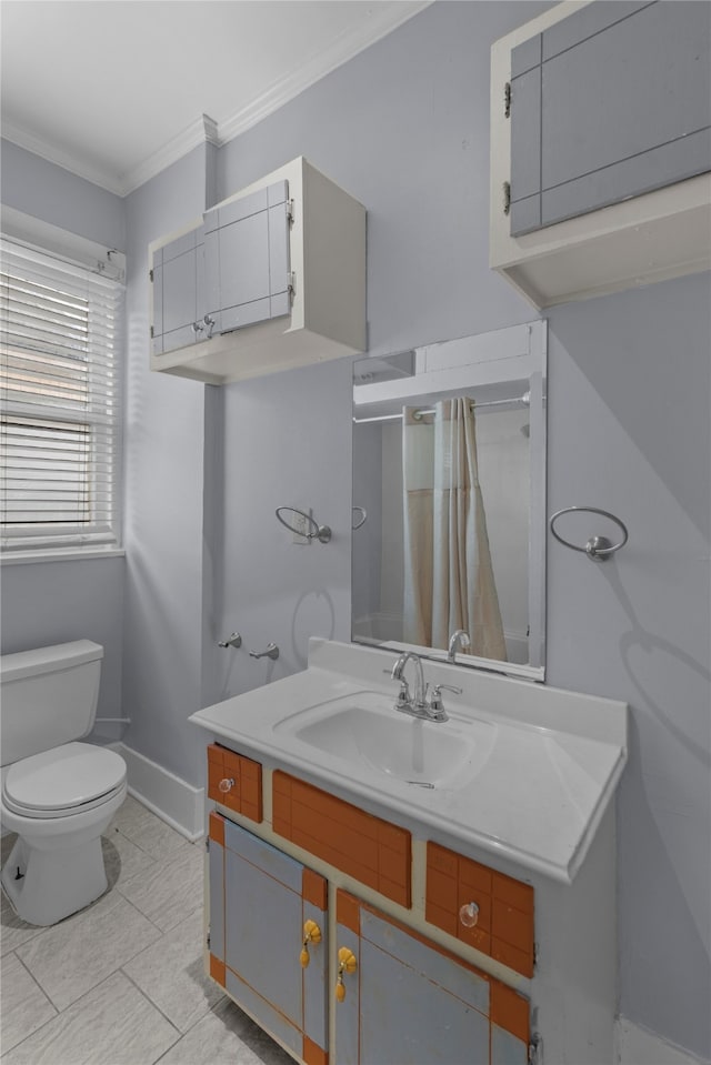 bathroom featuring toilet, vanity, and ornamental molding