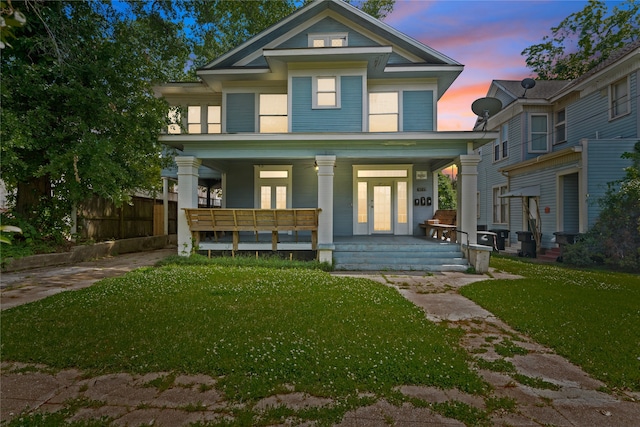 view of front facade featuring a porch and a yard