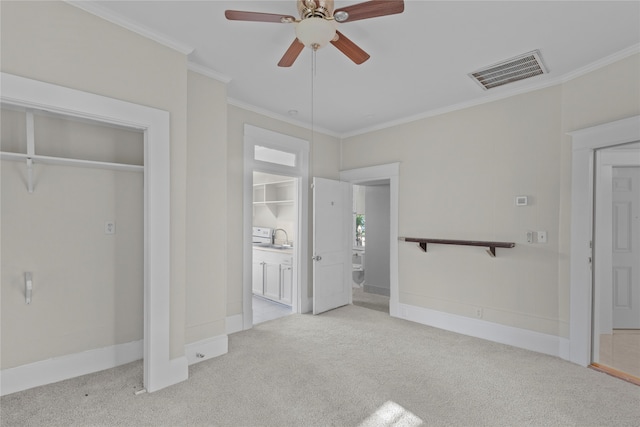 unfurnished bedroom with ceiling fan, light carpet, sink, and ornamental molding