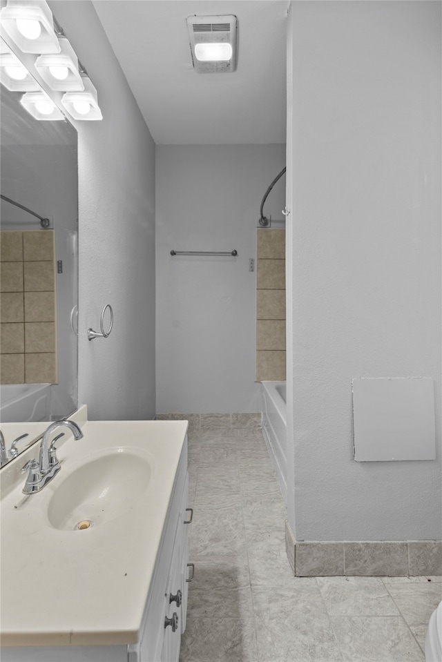 bathroom with tile patterned flooring, vanity, and shower / bathtub combination