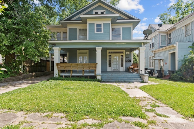 view of front of property featuring covered porch and a front lawn