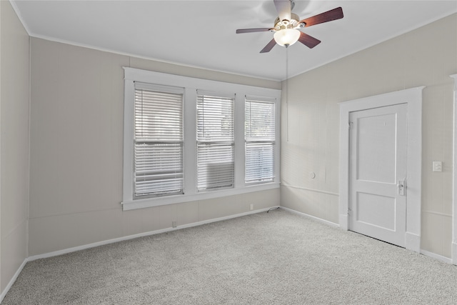 spare room featuring light carpet and ceiling fan